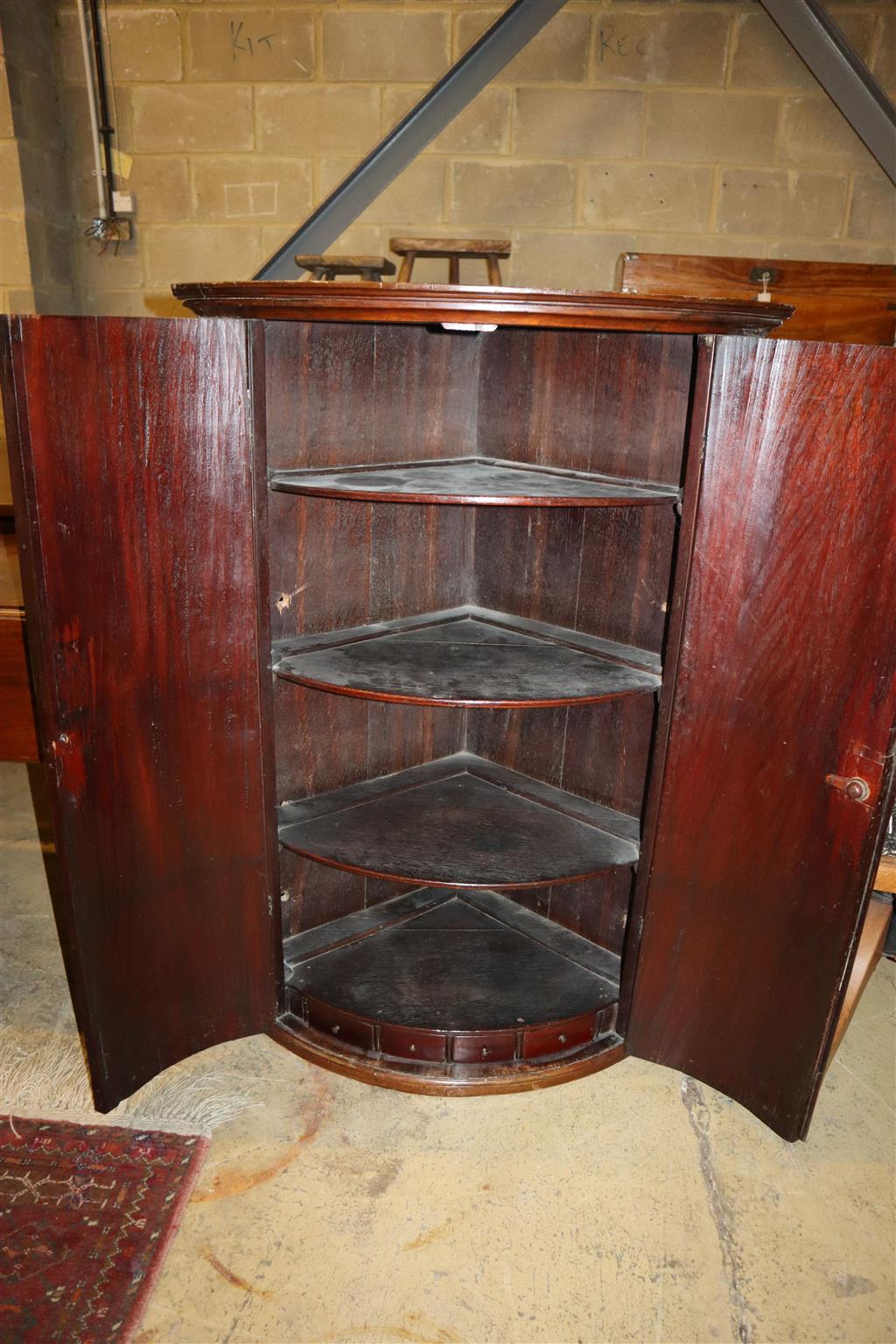 A George III mahogany bow front hanging corner cabinet, width 74cm, depth 48cm, height 108cm